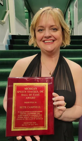 Beth Campbell holding her Hall of Fame plaque