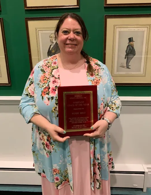 Wendy Holt holding her Coach of the Year plaque