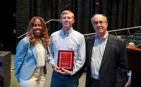 Ryan Nierman holding his award, with Dr. Roberson and John Lawson