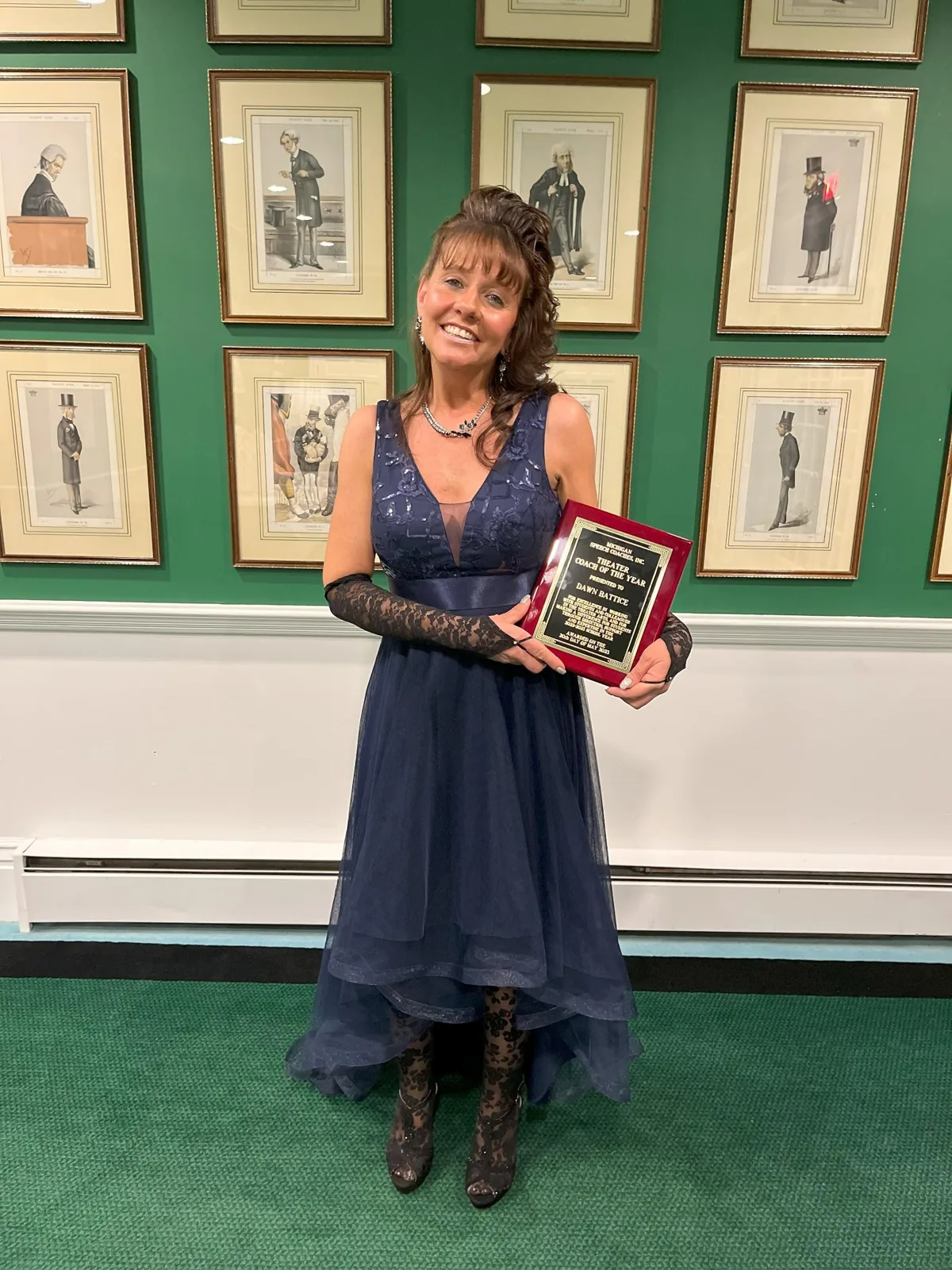 Dawn Battice holding her Coach of the Year plaque