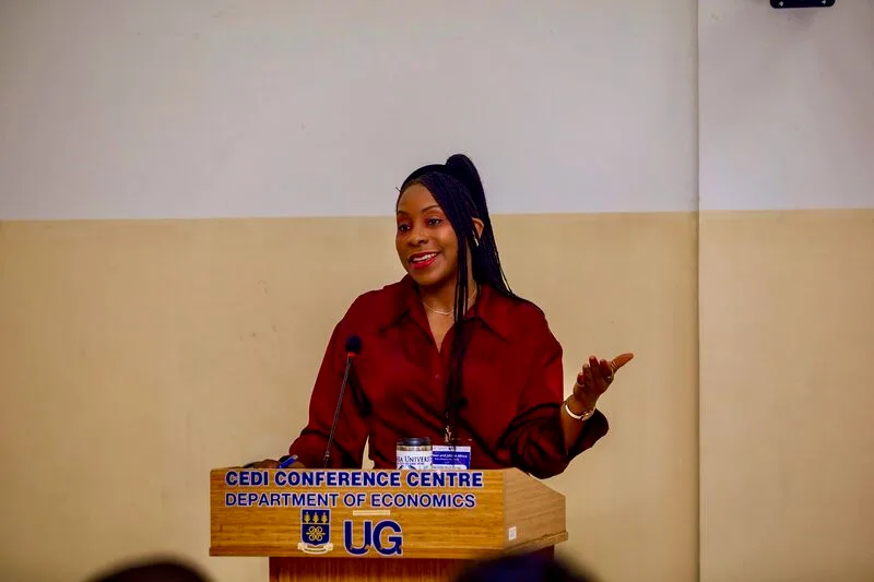 Belinda Archibong speaking from a lectern marked CEDI Conference Centre, Department of Economics, University of Ghana