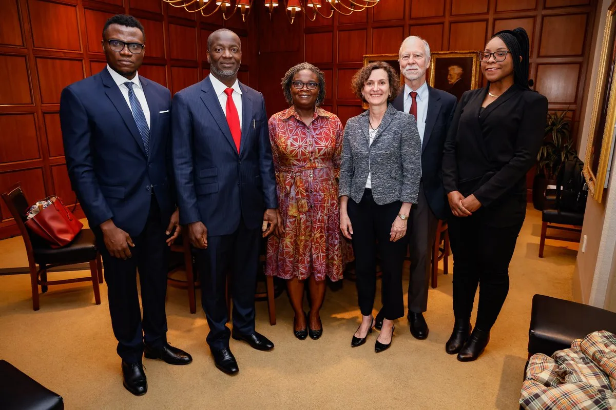 Belinda Archibong, far right, with five academic colleagues in a wood-panelled room