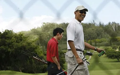 President Barack Obama and Eugene Kang walking a golf course carrying clubs