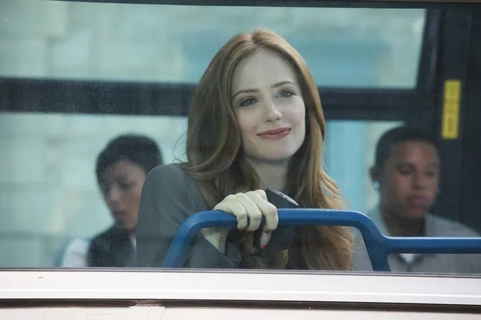 Jaime Ray Newman as Kat Gardener riding a bus in a scene from the TV series Eastwick