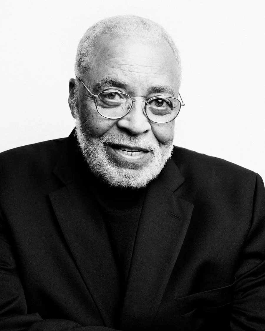 Black and white portrait of an elderly James Earl Jones in glasses and a dark jacket