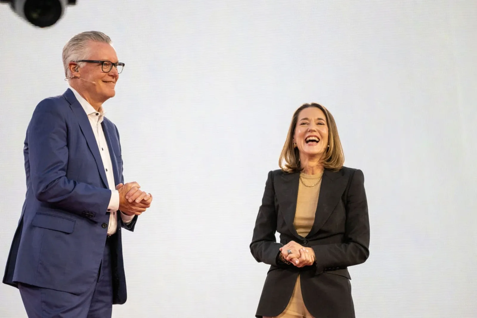 Mary Ellen Coe sharing a stage with Delta Air Lines CEO Ed Bastian