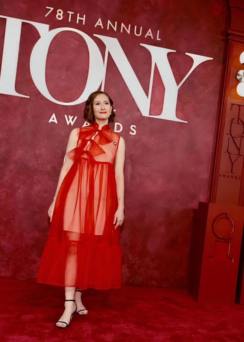 Rachel Sussman in a sheer red dress on the red carpet at the Tony Awards