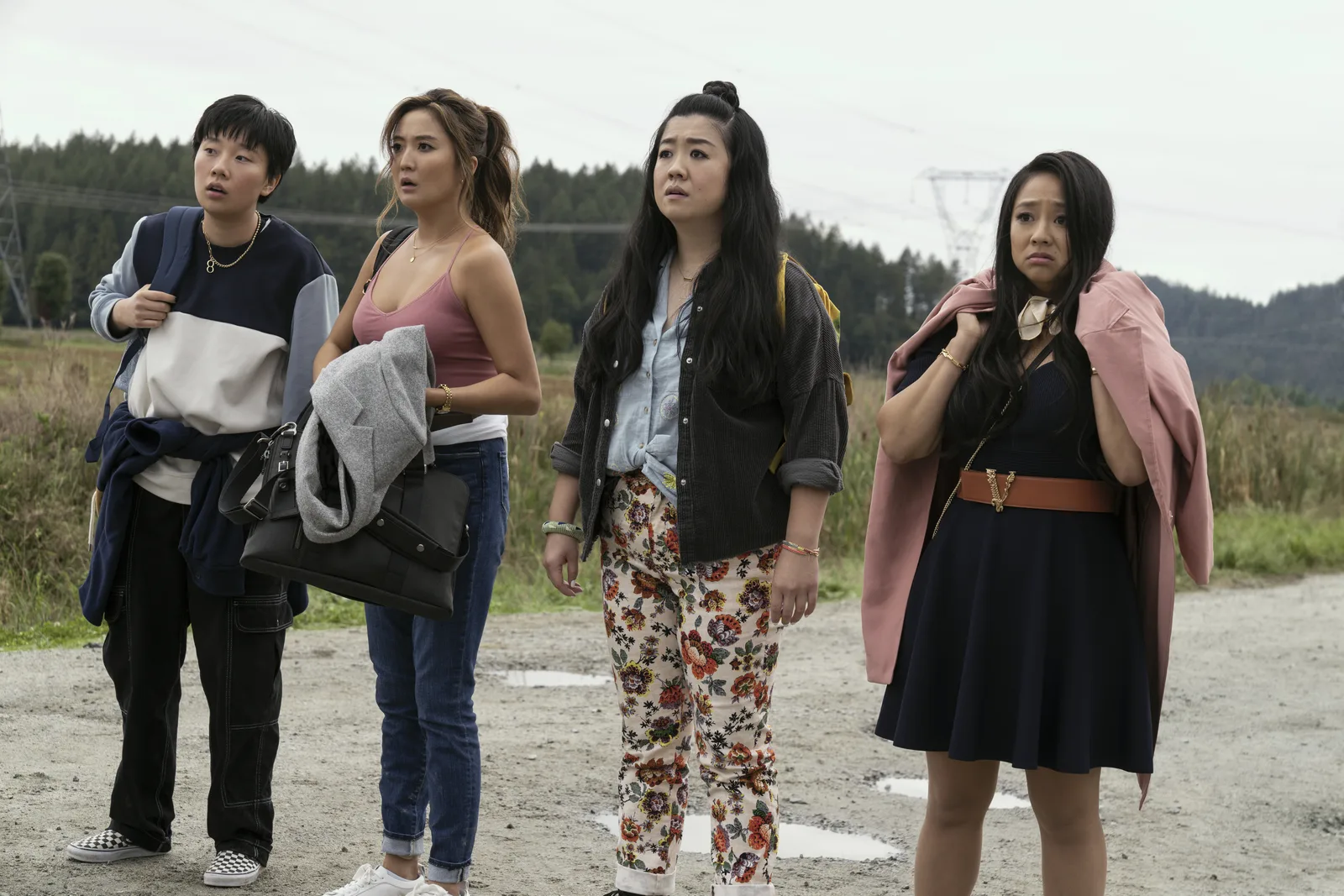 Sabrina Wu, at left, with three other performers standing on a gravel road in a film still