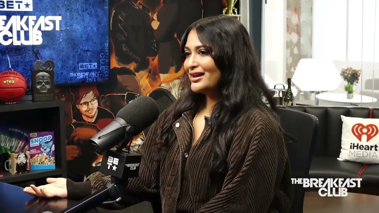 Sowmya Krishnamurthy seated at a microphone on The Breakfast Club studio set